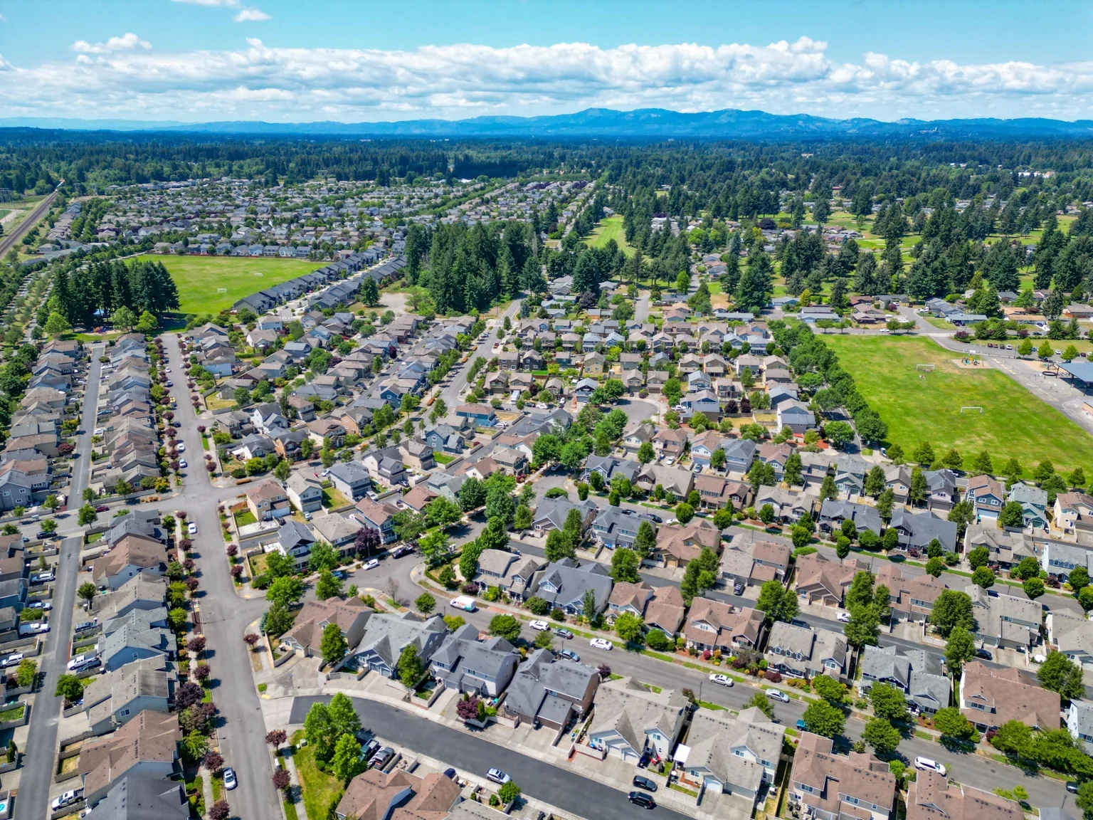 Wide aerial view of Horizon Pointe homes, parks, and surrounding Lacey landscape